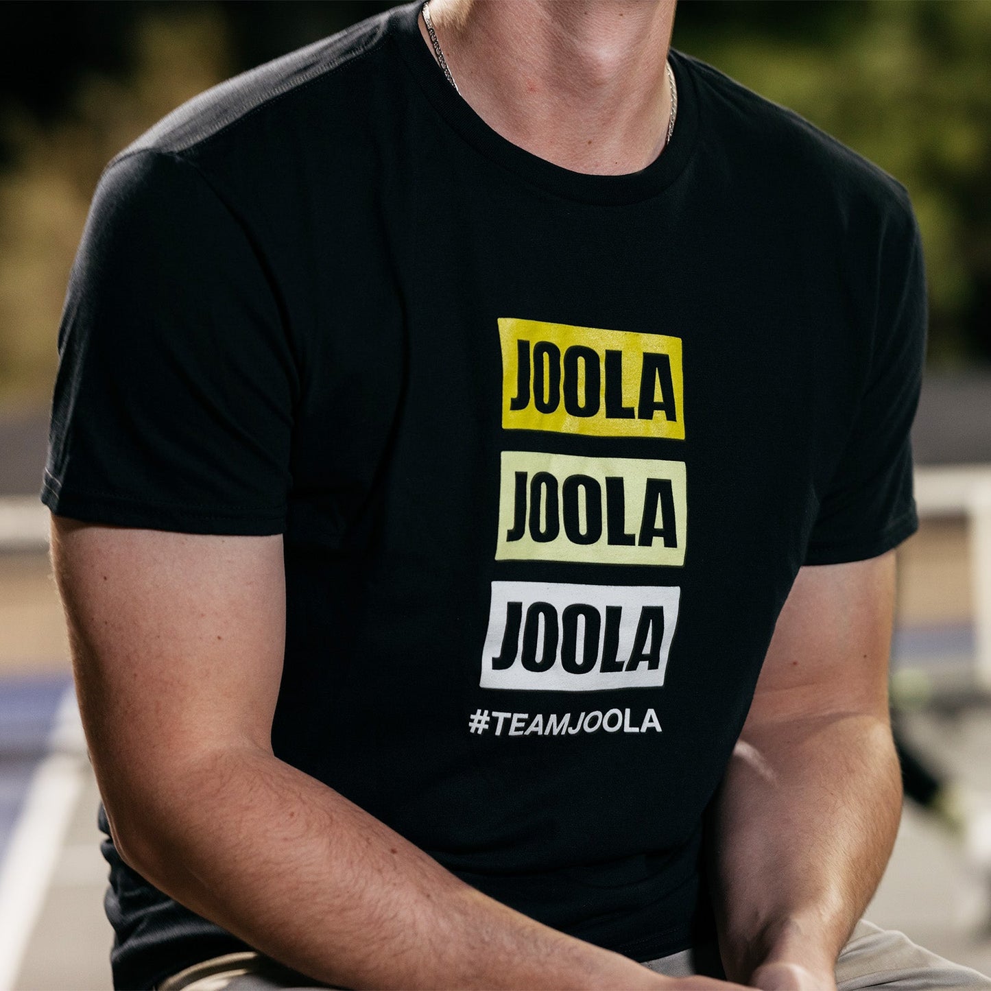Joola Team Joola Stacked Logo Tee featuring official stacked logo graphic on front