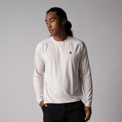 Gray Background, image of a male model wearing the JOOLA men's court long-sleeve shirt, sandstone.