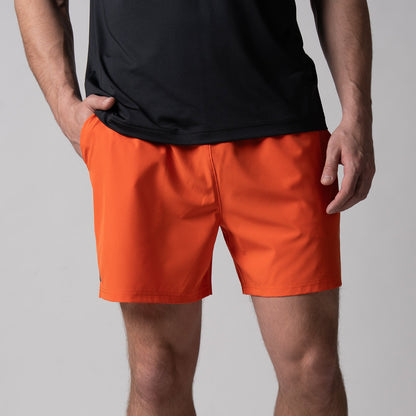 Gray background, close up image of the front of a pair of JOOLA Men's Woven Shorts, 5-inch, poppy red.