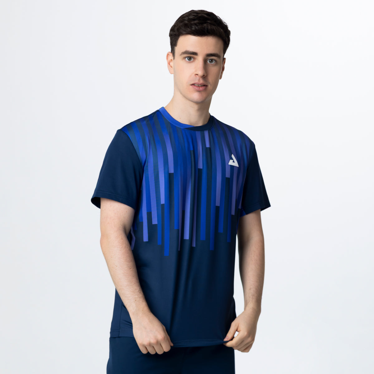 Man wearing a blue athletic shirt with a brand logo on a white background