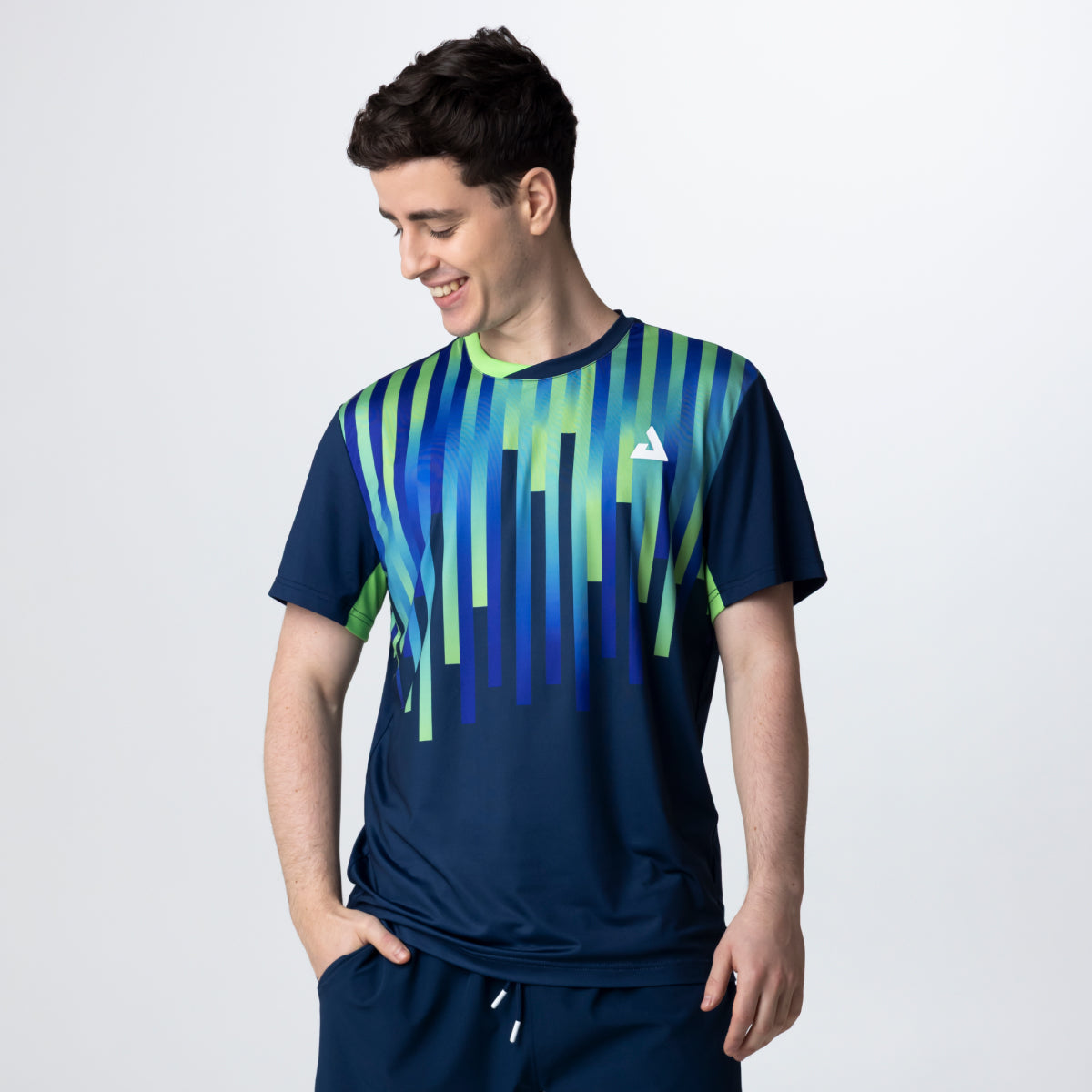 Man wearing a blue and green striped sports outfit on a white background