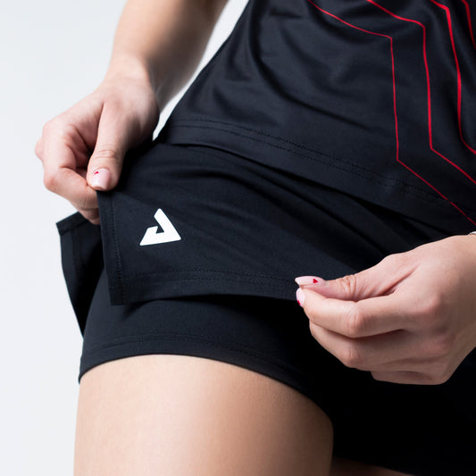 Close up on the JOOLA Trinity logo on a the JOOLA Essential Skirt, black and white.