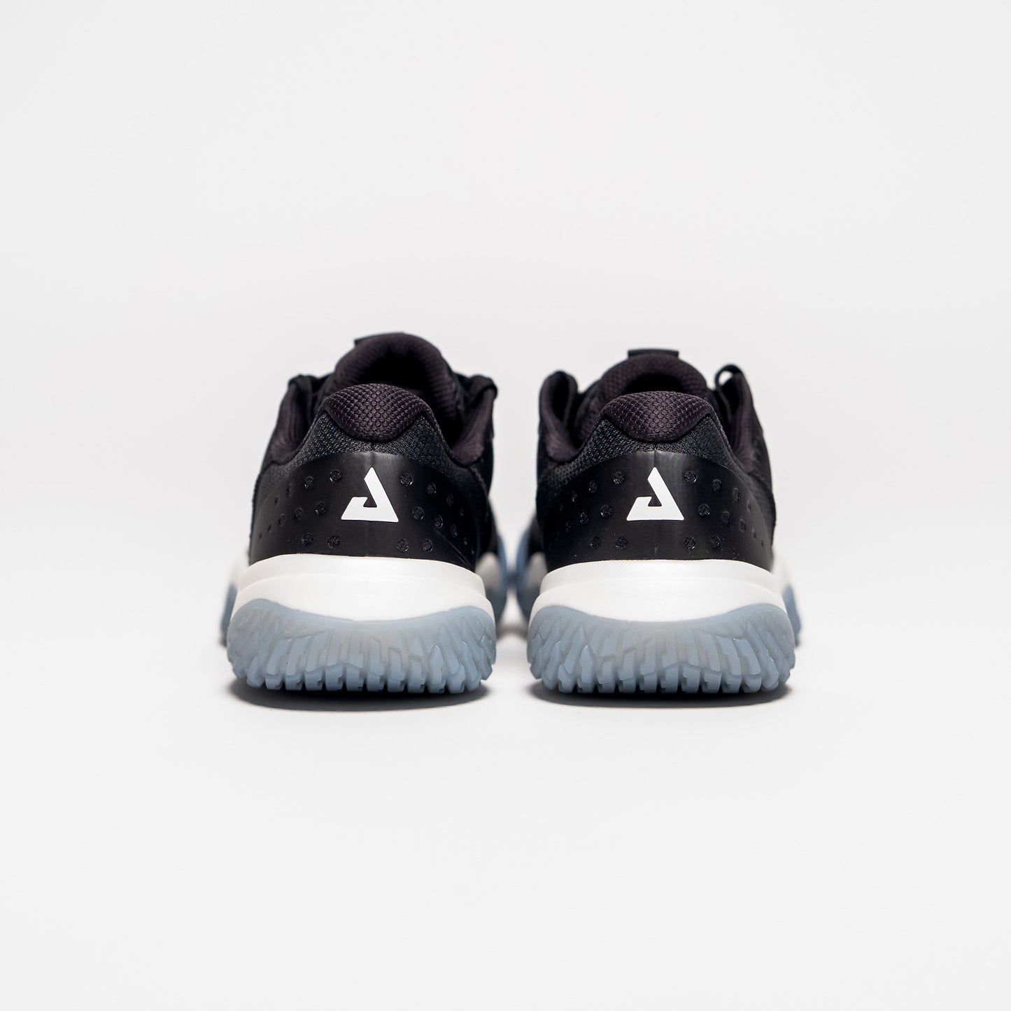 White background, product image showing the JOOLA Trinity logo on the back of a pair of black JOOLA R4LLy pickleball shoes.