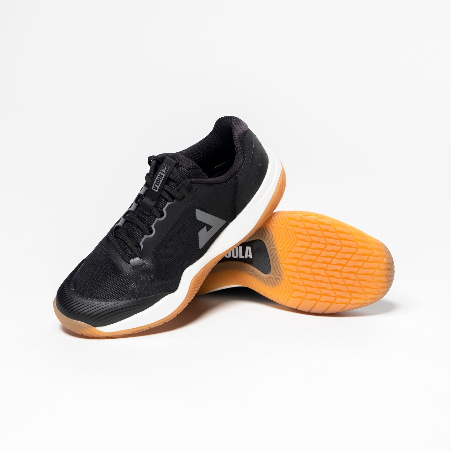 White background, image of a pair of Men's R4LLy pickleball shoes, black shoes with gum sole.