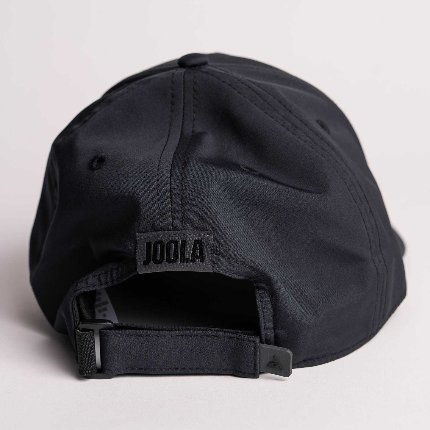 White background, product image showing the back of a JOOLA Essential Cap, black.