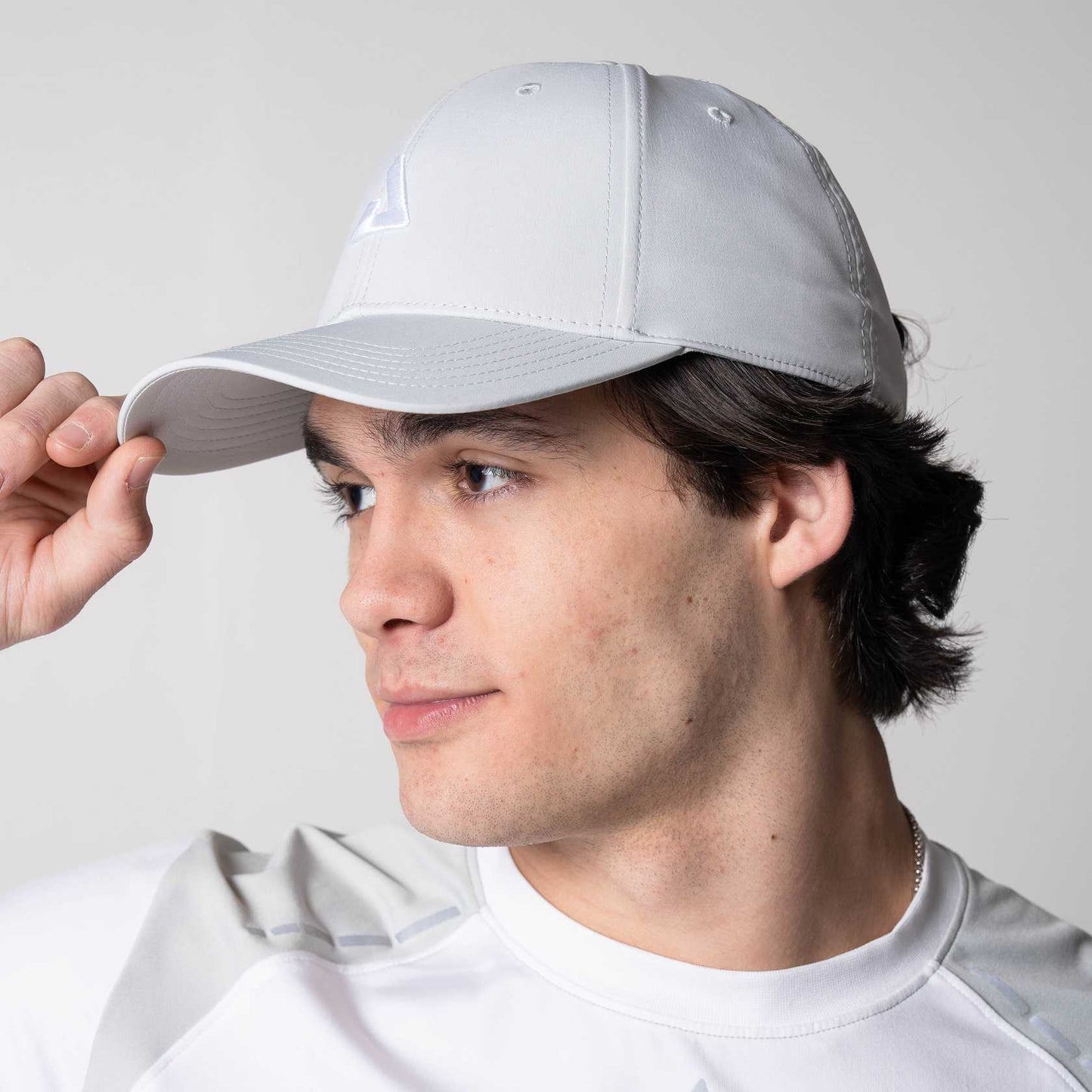 Gray background, image of a male model wearing a JOOLA Essential Cap, Gravity Gray.