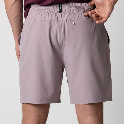Close up image showing the back zipper pocket and JOOLA logo on the waistband of a pair of JOOLA Men's Woven Shorts, 7 inch inseam, dusty mauve.