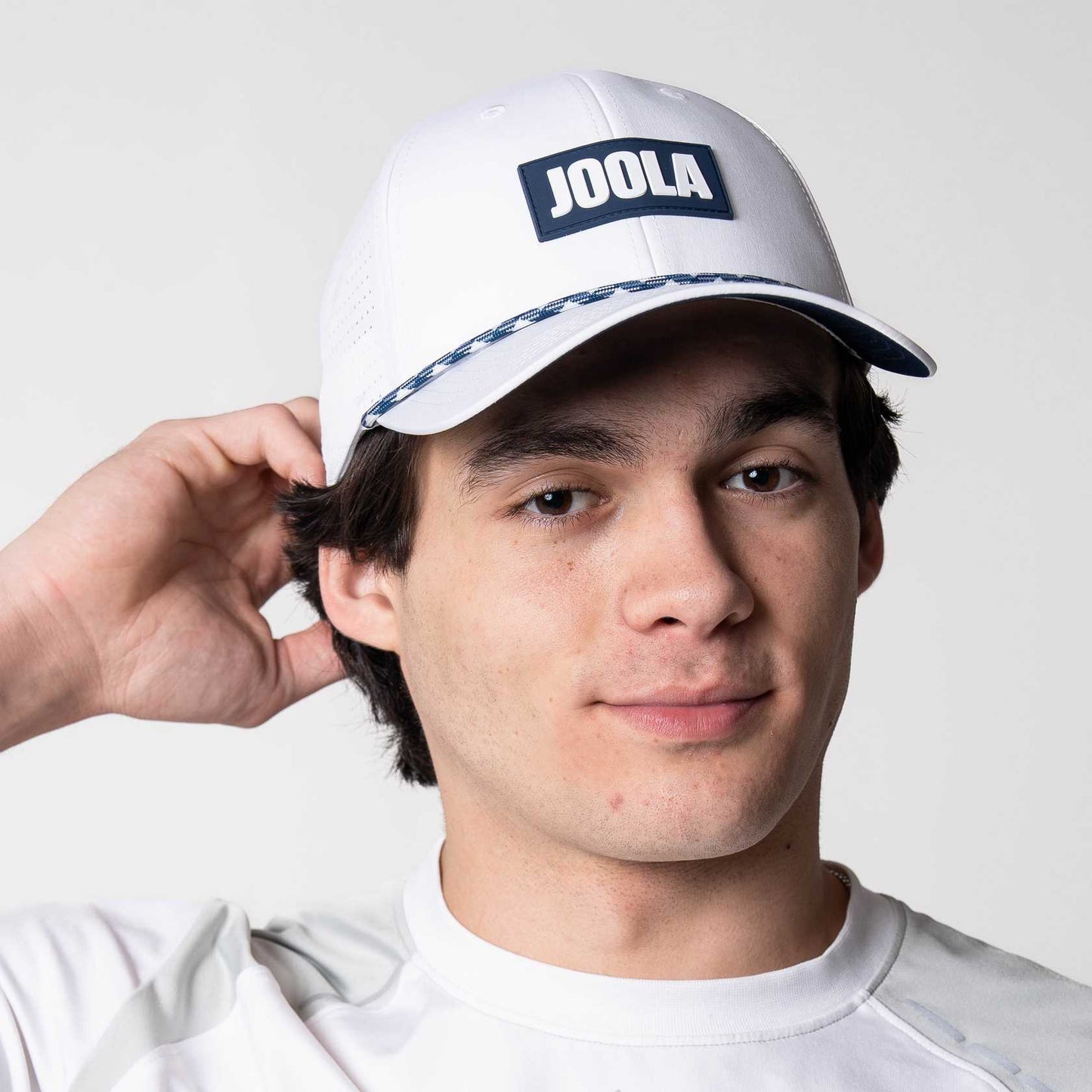 Model showing off the JOOLA Rope Cap, blue and white.